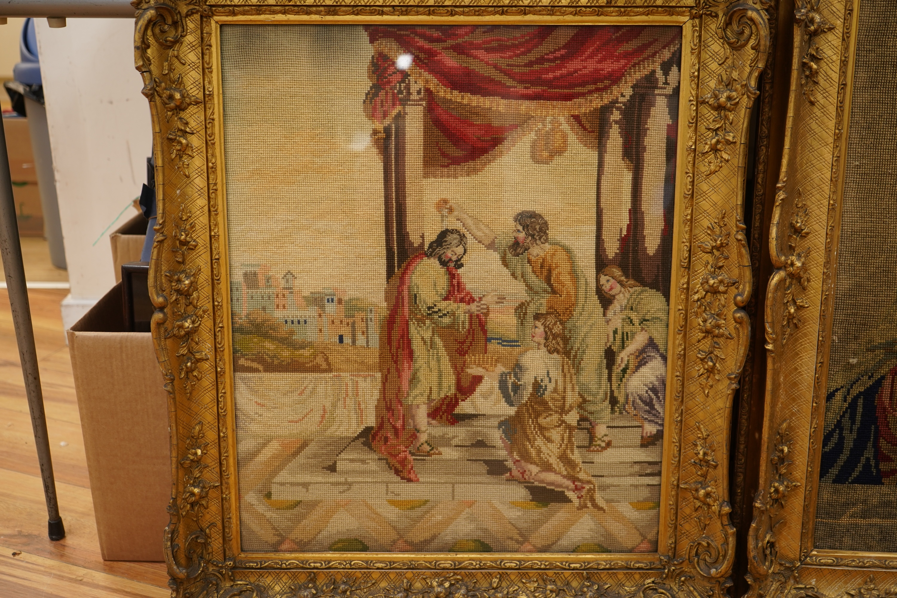 Two Victorian woolwork embroideries, one depicting Christ, the other John the Baptist both in carved gilt frames, largest 82cm high x 66cm wide